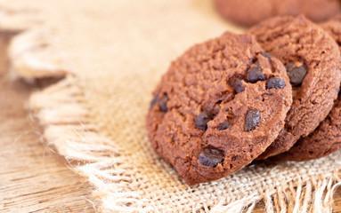 Chocolate chip cookies on sackcloth on the table. Copy space for your text or image.