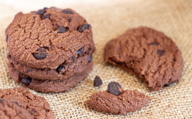 Chocolate chip cookies on sackcloth on the table. Copy space for your text or image.