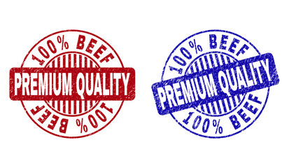 Grunge 100% BEEF PREMIUM QUALITY round stamp seals isolated on a white background. Round seals with grunge texture in red and blue colors.