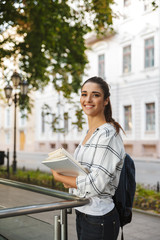 Pretty girl student reading a book