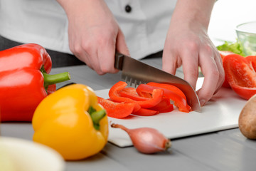 Man slicing a red pepper