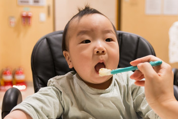 Asian baby eating baby food