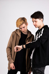 two young guys posing on a white background