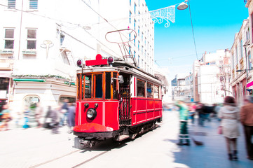 Old red tram goes on Istiklal street	