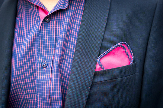 View To The Young Man's Shirt And Coat With A Pocket A Reddish-purple Square. Men's Suit Accessories. Wedding Male Guest's Attire. Male Style. Formal Dinner Outfit For Men. Unbuttoned Male Collar.