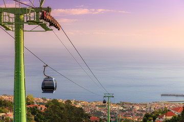 Beautiful cityscape view over the city of Funchal, Madeira,  with the cable car going up Monte...