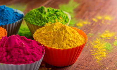 Holi color powder. Organic Gulal colours in bowl for Holi festival, Hindu tradition festive