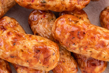 Tasty grilled sausage on the wooden background