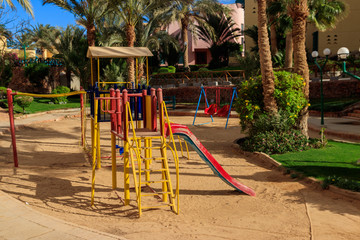 Colorful playground equipment for children in tropical holiday resort