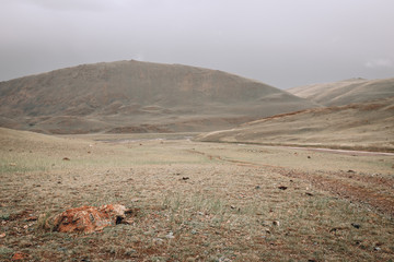 a scene of beautiful and majestic mountainous mountains against the background of a cloudy sky with...