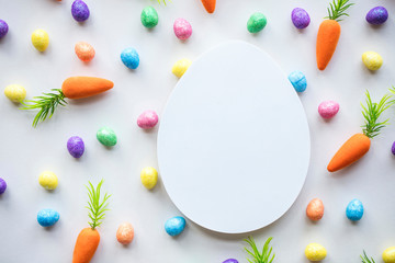 Easter seasonal background with colourful eggs and carrots