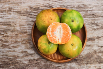Fresh tangerines on wooden tray