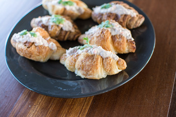 Croissant with Tuna Salad  Sandwich on wood table