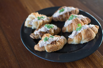 Croissant with Tuna Salad  Sandwich on wood table