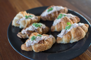 Croissant with Tuna Salad  Sandwich on wood table