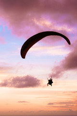 silhouette of paraglider in sunset
