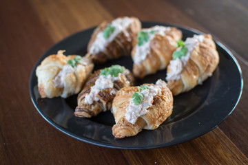 Croissant with Tuna Salad  Sandwich on wood table