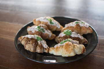 Croissant with Tuna Salad  Sandwich on wood table