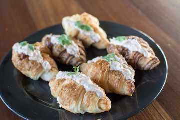 Croissant with Tuna Salad  Sandwich on wood table