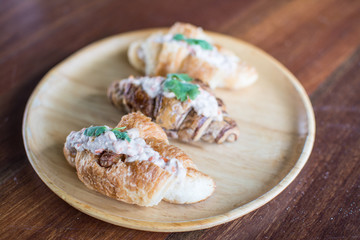 Croissant with Tuna Salad  Sandwich on wood table