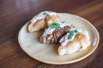 Croissant with Tuna Salad  Sandwich on wood table