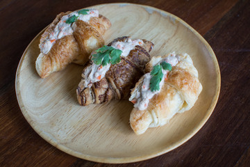 Croissant with Tuna Salad  Sandwich on wood table