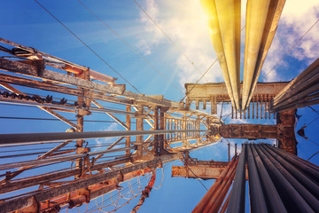 Onshore land rig in oil and gas industry. Oil drilling rig against a blue sky with clouds