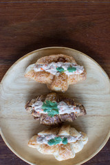 Obraz na płótnie Canvas Croissant with Tuna Salad Sandwich on wood table