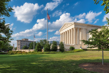 Fototapeta na wymiar United States Supreme Court Building and US national flag at sunny day in Washington DC, USA.