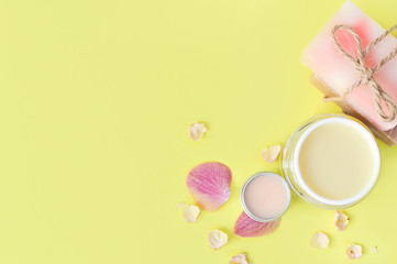 Cosmetic creams, lip balt on a yellow background.Spa beauty care. Space for a text. Copy space. spa flat lay. Pink, blue. The concept of beauty and personal care. Natural handmade.