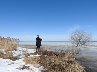 The man from behind, photographed in winter, the frozen lake Pleshcheyevo, Yaroslavl oblast, Pereslavl Zalessky.