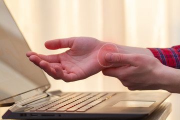 Wrist pain because of long work at laptop. Tunnel syndrome. Professional disease and hand pain