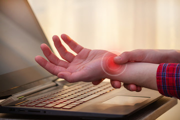 Wrist pain because of long work at laptop. Tunnel syndrome. Professional disease and hand pain