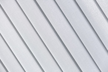 Obraz premium White abstract background with a shallow texture and oblique guide lines.