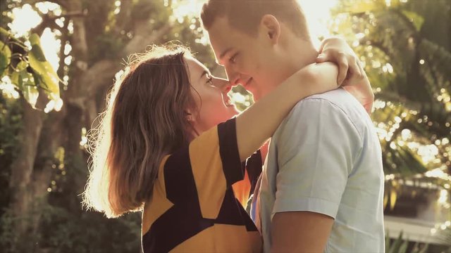 couple romantic scene in park sunset