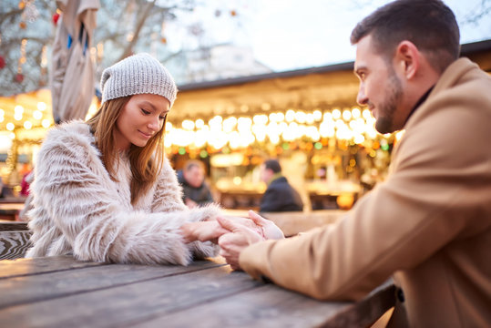 Couple holding hands in a christmas market