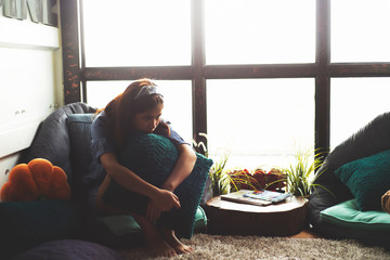 Sad young asia woman sitting at living room