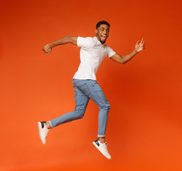 Fototapeta na wymiar Funny young black man walking on air
