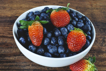 strawberries and blueberries in a bowl