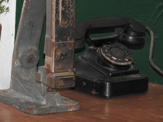 Disk dialer of old vintage black phone close-up.