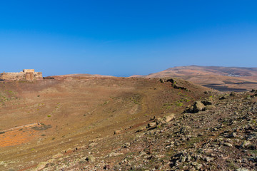 Spain, Lanzarote, Hiking trail alongside volcanic crater on guanapay mountain from castle santa barbara