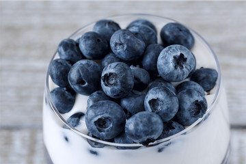 Ripe blueberries on yogurt