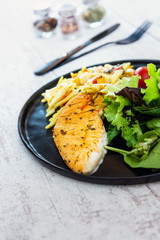 close-up of plate of pasta and chicken with lettuce