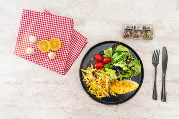 close-up of plate of pasta and chicken with lettuce