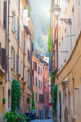 Fototapeta na wymiar Colorful street with sunlight in Rome, Italy