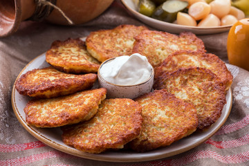 Potato pancakes with sour cream. The naitonal dish of Belarus.  Draniki. Closeup