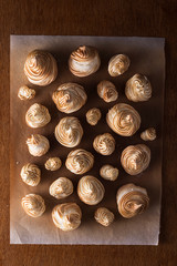 Out of the oven meringues over parchment paper.