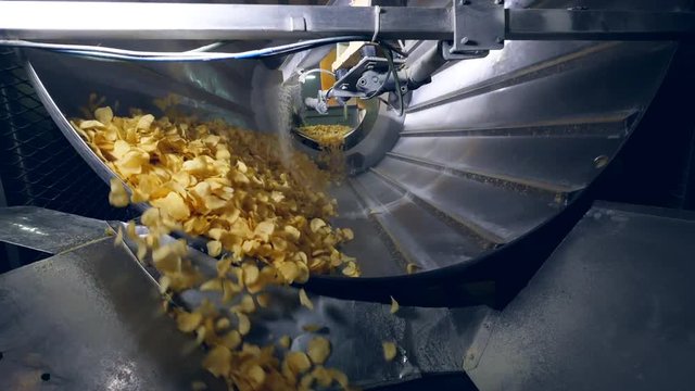 Sorted potato chips mixing with a flavor enhancers.