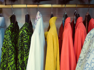 Multi-colored coat hanging on hangers. sales season