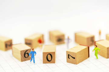 Miniature people running before wooden box number.Business career growth,  achievement, success., victory or top ranking Concept.